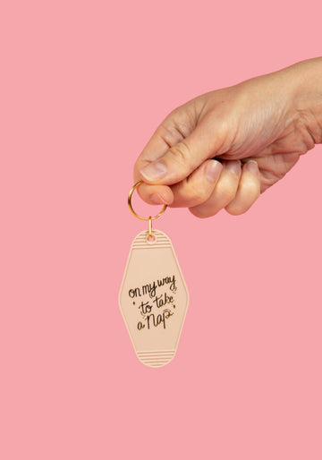 on my way to take a nap in beige style with gold hand draw lettering design held in hand
