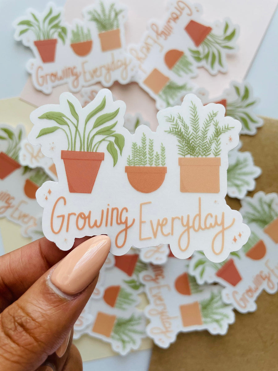 growing everyday potted plants clear sticker. 3 potted plants lined up with the phrase "growing everyday" below it written in hand lettered font
