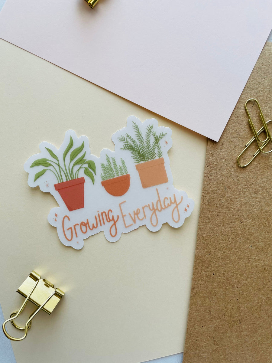 growing everyday potted plants clear sticker. 3 potted plants lined up with the phrase "growing everyday" below it written in hand lettered font