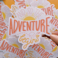 And so the adventure begins glossy vinyl sticker. A hand drawn sticker with sun rising and paper airplane 