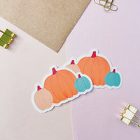 3 pumpkins in one vinyl sticker, one large orange pumpkin in the middle, one medium size cream pumpkin on the left, and one small teal pumpkin on the right
